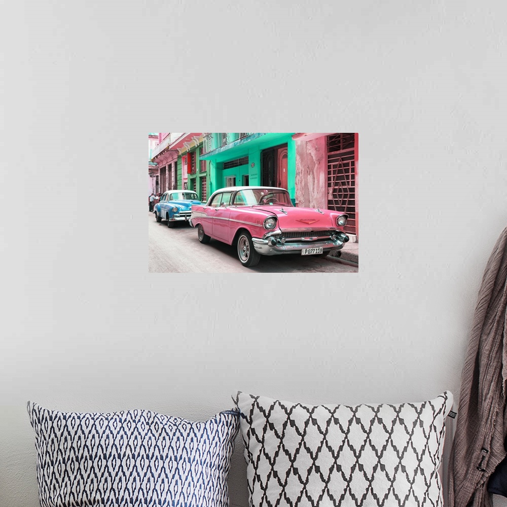 A bohemian room featuring Photograph of a pink Chevrolet parked outside of brightly colored Cuban facades.