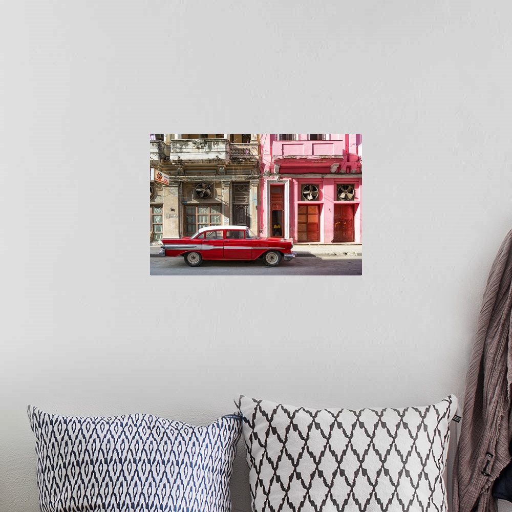A bohemian room featuring Photograph of a red vintage car with white details parked in the street, Havana, Cuba