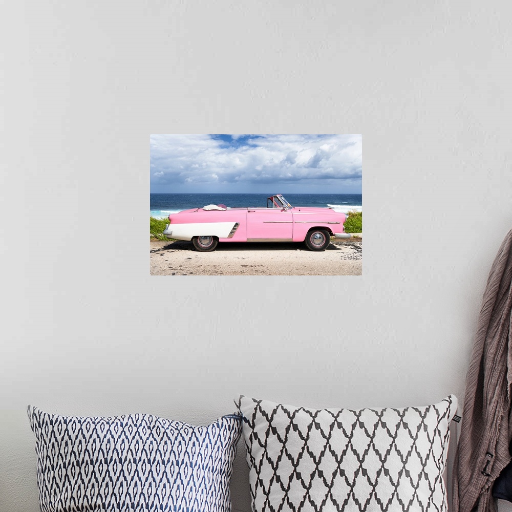 A bohemian room featuring Photograph of a light pink and white vintage convertible parked in front of the ocean.
