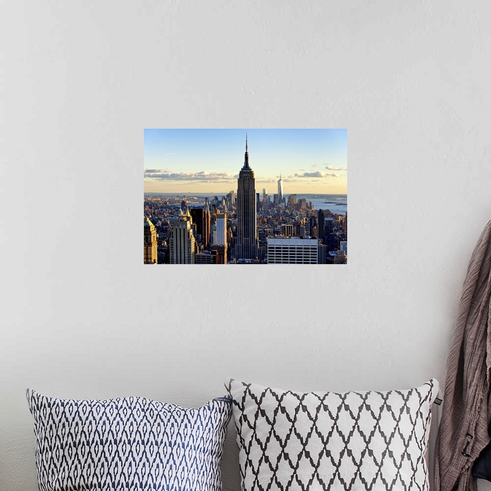 A bohemian room featuring A sunset creates dramatic lighting on the Empire State Building and New York skyscrapers.