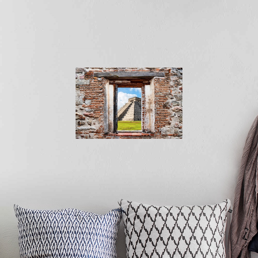 A bohemian room featuring View of El Castillo Pyramid in Yucat?n, Mexico, framed through a stony, brick window. From the Vi...