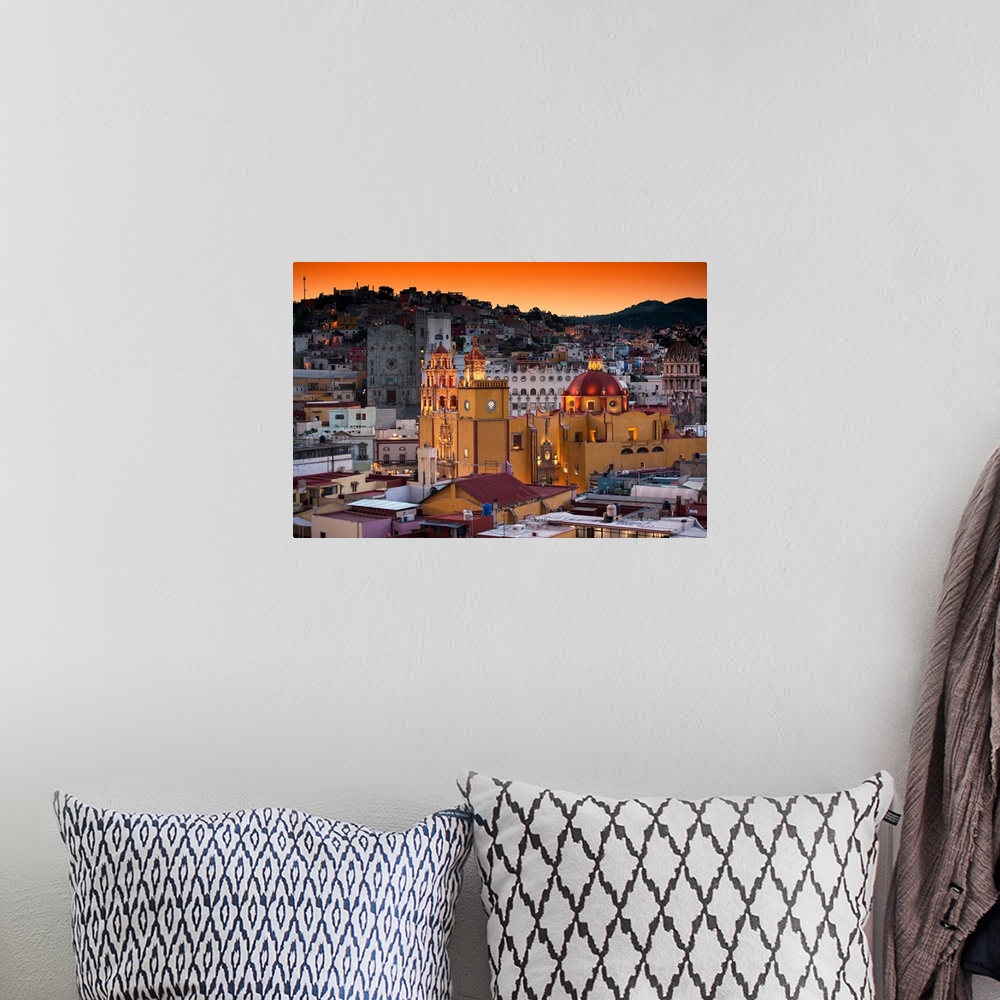 A bohemian room featuring Photograph of a Guanajuato cityscape featuring the iconic Yellow Church at twilight under orange ...