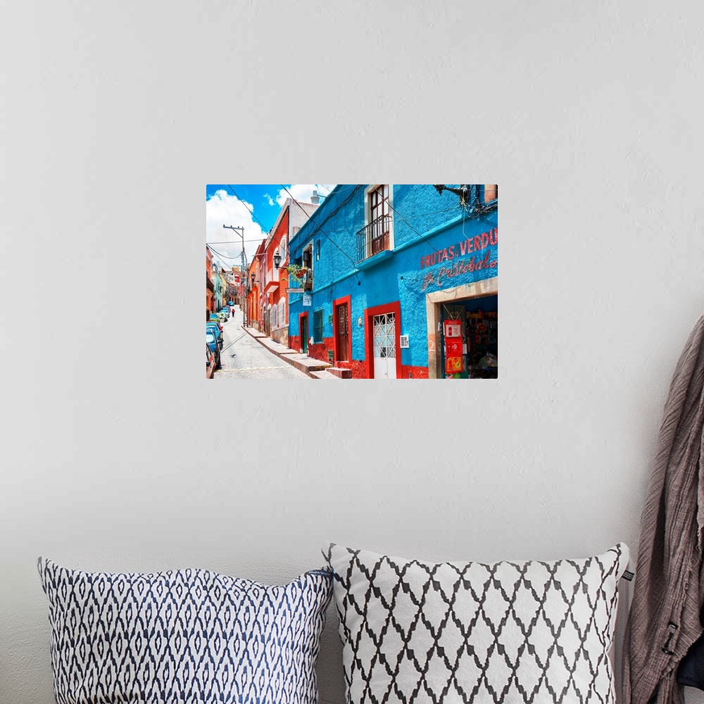 A bohemian room featuring Colorful streetscape photograph in Guanajuato, Mexico with bright blue and red buildings. From th...