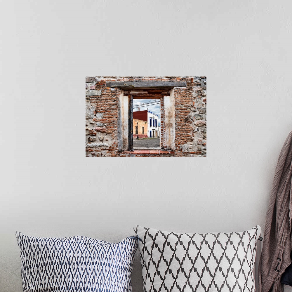 A bohemian room featuring View of a streetscape in Mexico framed through a stony, brick window. From the Viva Mexico Window...