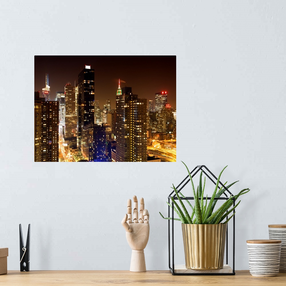 A bohemian room featuring A fine art photograph of New York city's Manhattan lit up at night.