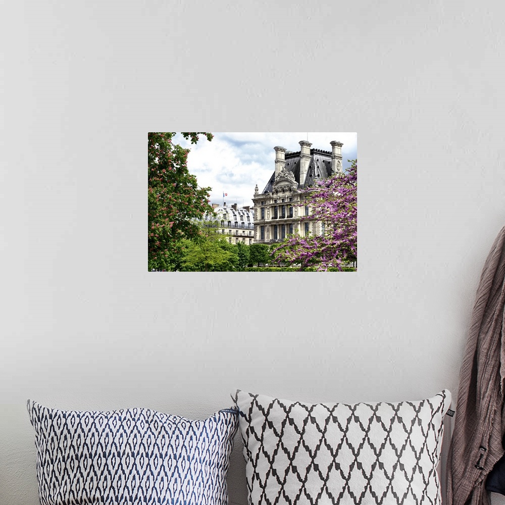 A bohemian room featuring Trees in full bloom frame classic French architecture on a beautiful spring day.