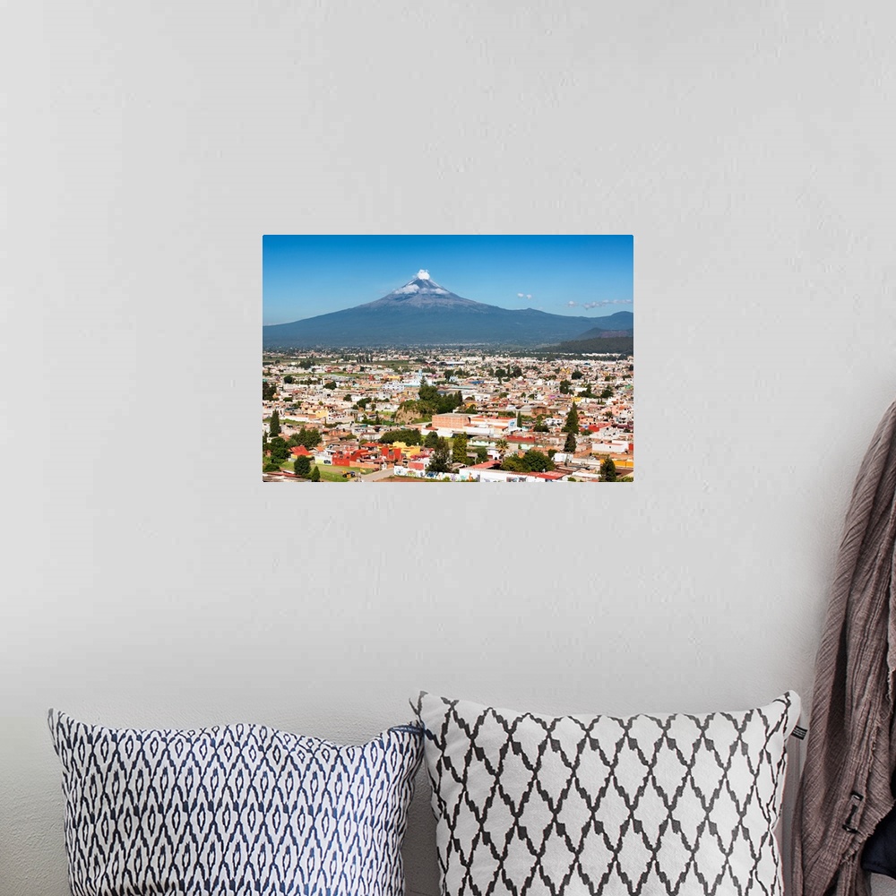 A bohemian room featuring Aerial photograph of the Popocatepetl Volcano in Puebla, Mexico, with a bird's eye view of the ci...