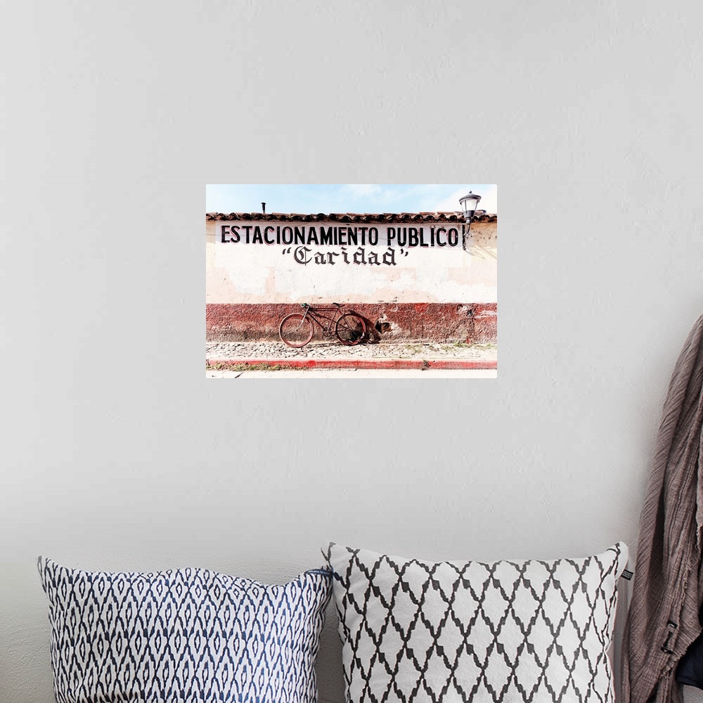 A bohemian room featuring Photograph of a red bicycle parked in front of a wall with the phrase "Estacionamiento publico" (...