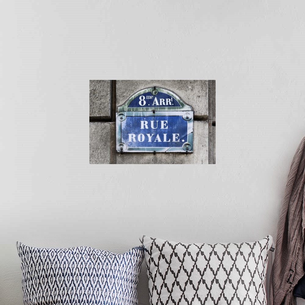 A bohemian room featuring Photograph of a Parisian sign against a stone wall.