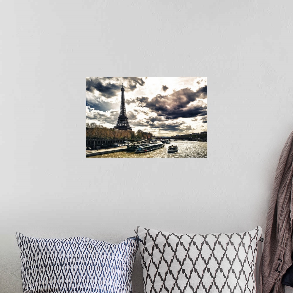 A bohemian room featuring Fine art photo of the Eiffel Tower on the edge of the Seine River with dramatic clouds.