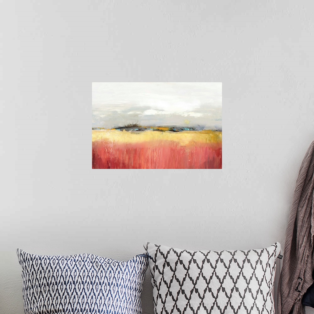 A bohemian room featuring Landscape painting of a yellow field under an overcast sky.