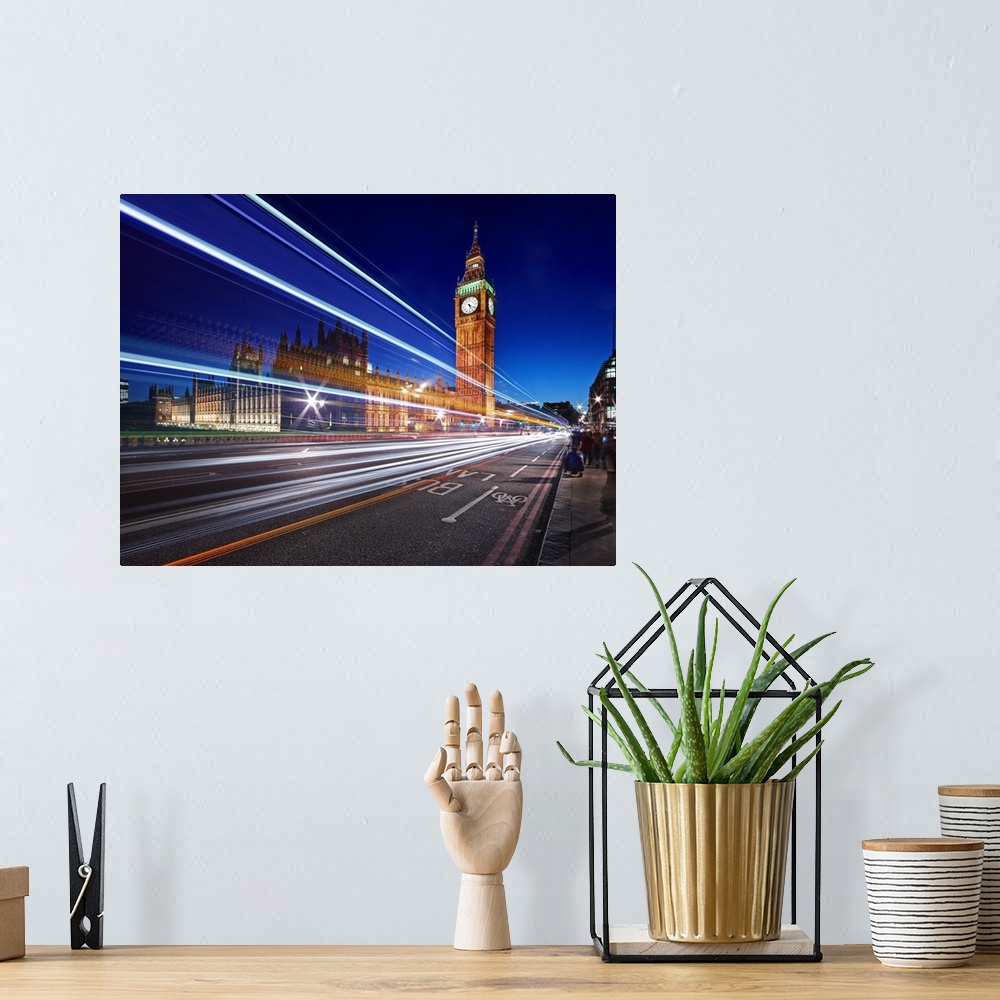 A bohemian room featuring Light trails from passing cars in front of Big Ben and Parliament in London, England, in the even...