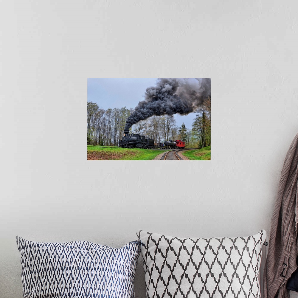 A bohemian room featuring A locomotive with billowing black smoke climbs up a hill.