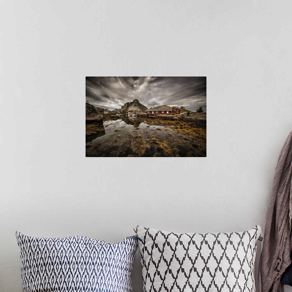 A bohemian room featuring Dynamic photograph of a fishing village under cloudy skies.