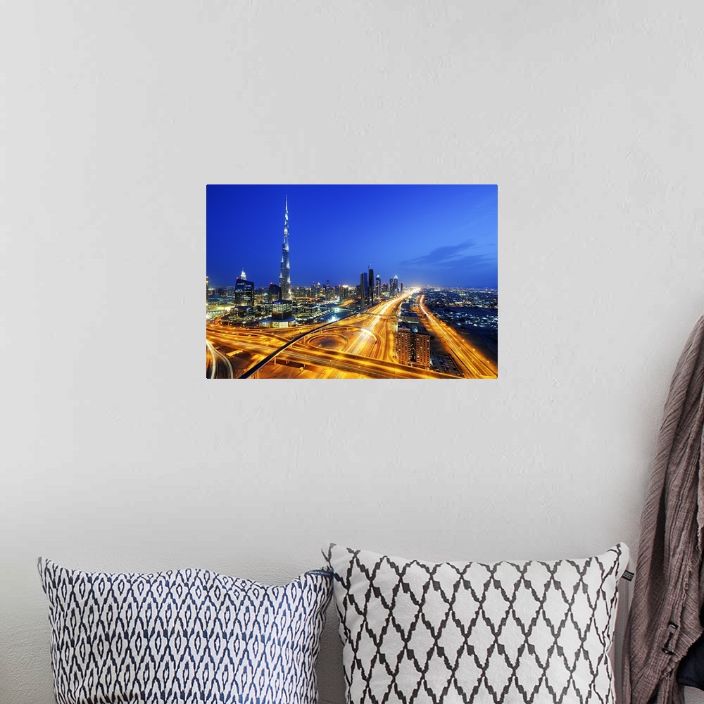 A bohemian room featuring Aerial photograph of Dubai city skyline at night, with light trails filling the city streets below.