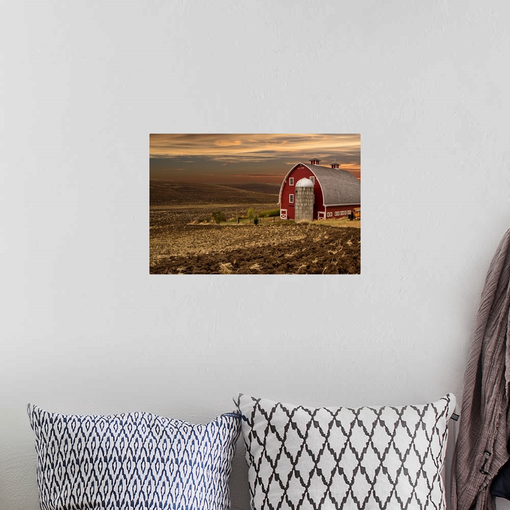 A bohemian room featuring Large red barn at sunset, Palouse, Washington.