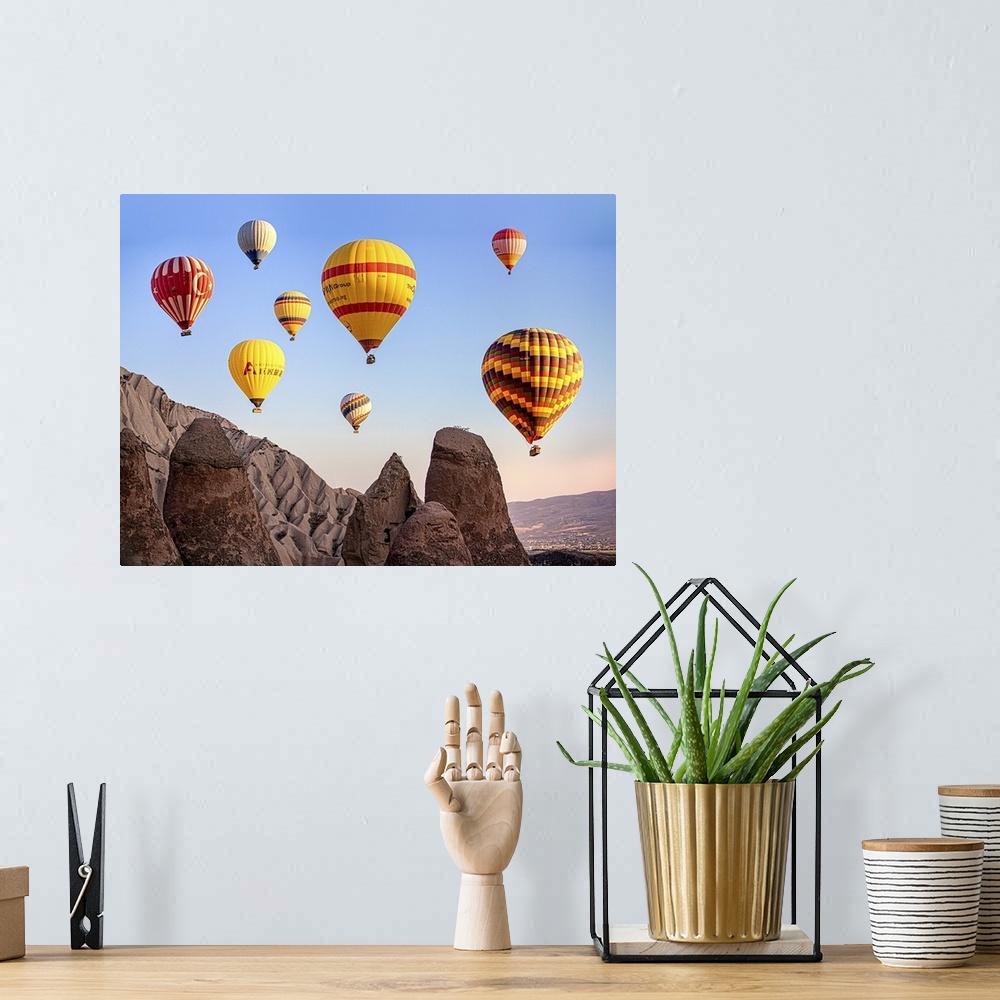 A bohemian room featuring Large, colorful hot air balloons floating in the sky over Cappadocia, Turkey.