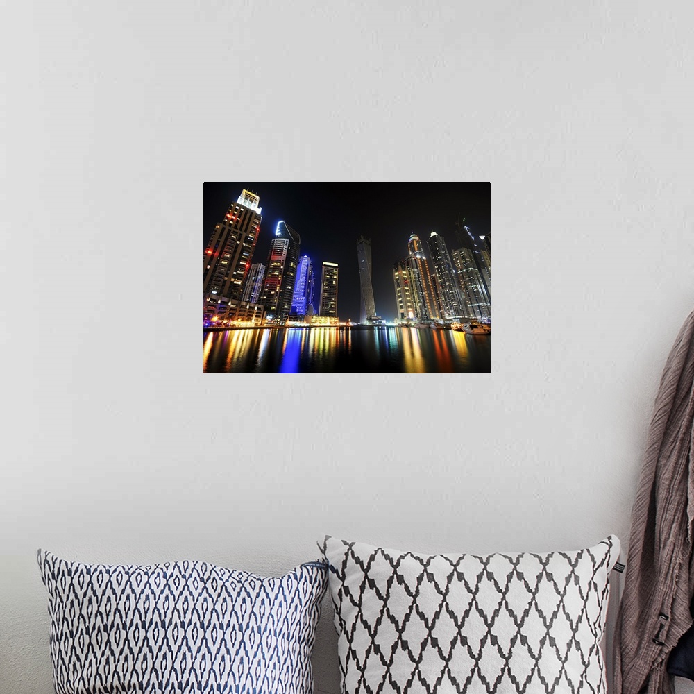 A bohemian room featuring Photograph of a dramatic view of a city skyline lit up in bright lights at night.