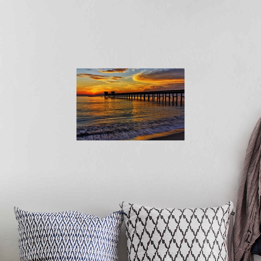 A bohemian room featuring Sunrise over the water from a beach.