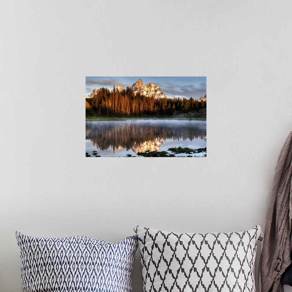 A bohemian room featuring An image of the Grand Tetons at sunrise.