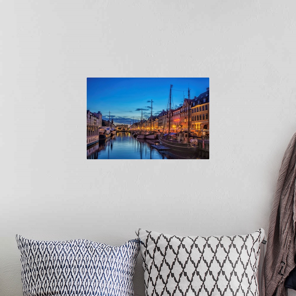 A bohemian room featuring Waterfront with boats in the evening, Copenhagen, Denmark.