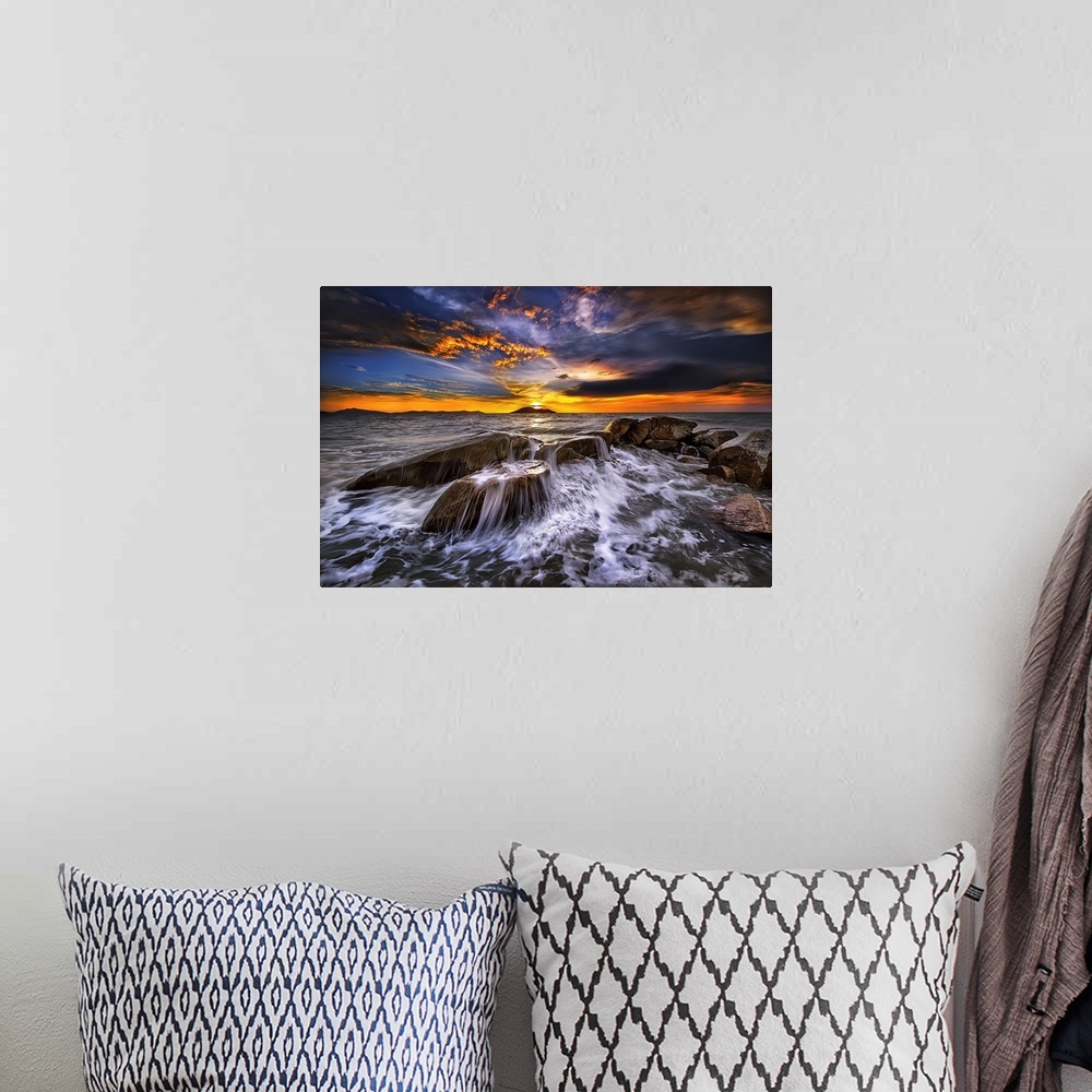 A bohemian room featuring Photograph of a seascape at sunset with intense warm and cold clouds in the sky.