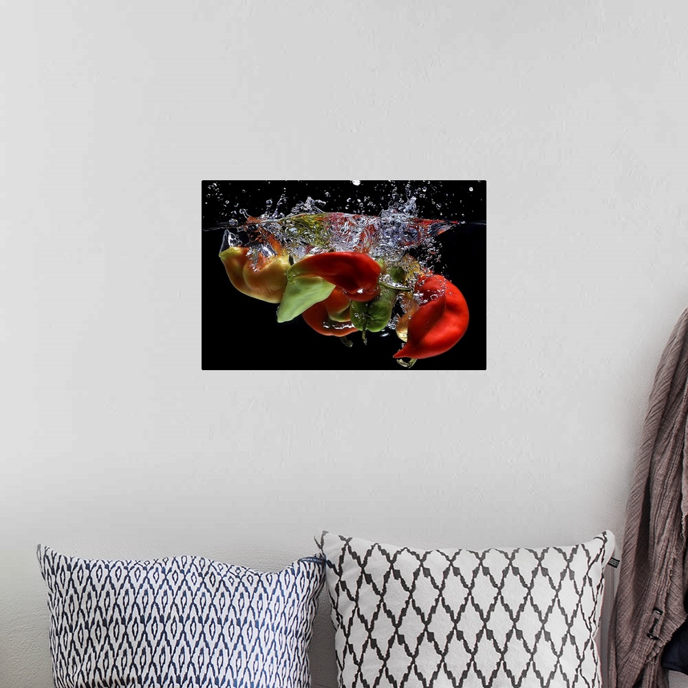 A bohemian room featuring Peppers falling into water, over black background.