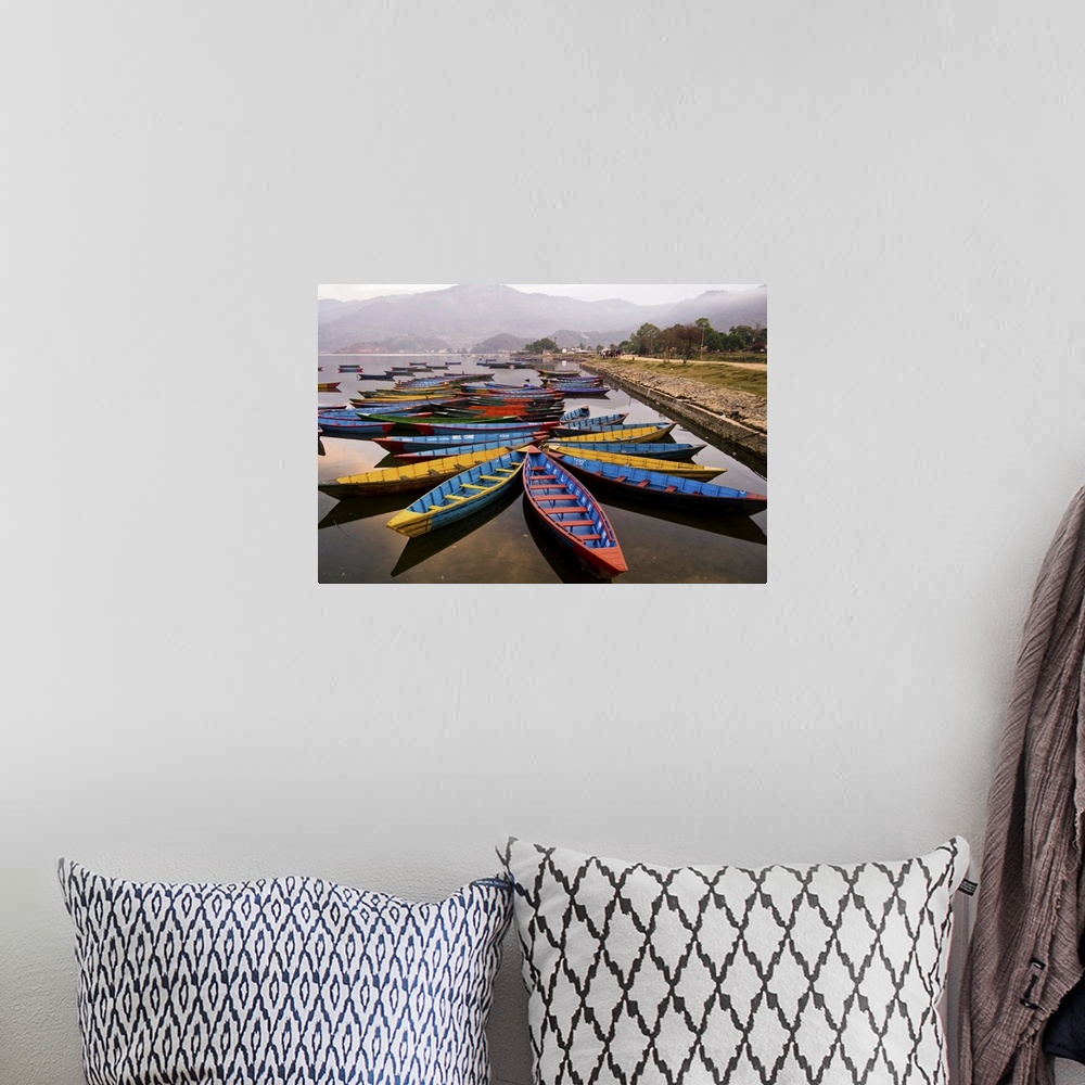 A bohemian room featuring Long tail boats in star formations in a misty harbor in Nepal.