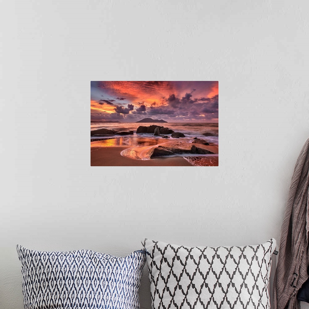 A bohemian room featuring Rocky beach at sunset, with dramatic clouds looming in the distance.
