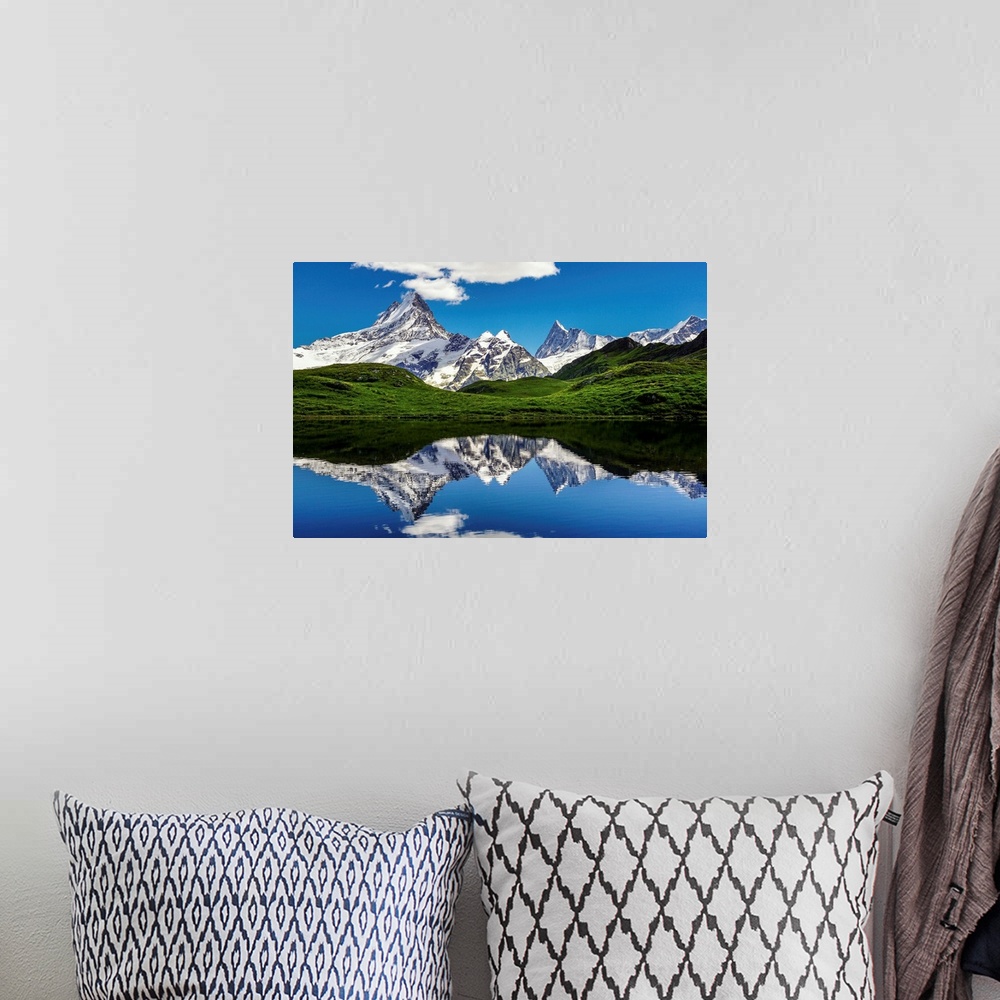 A bohemian room featuring Mountains of the Swiss Alps reflected in the lake Bachalpsee.