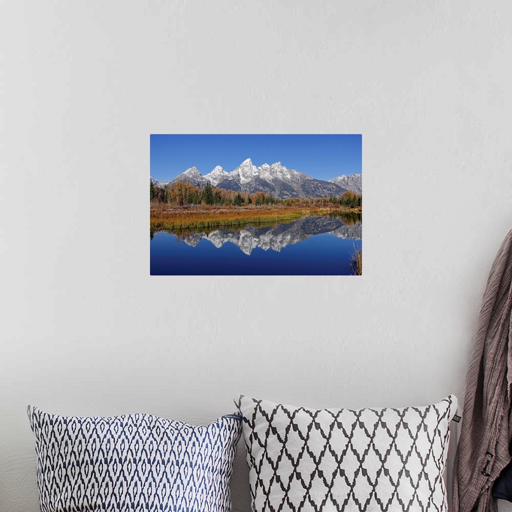 A bohemian room featuring The Grand Tetons reflected on the Snake river near Jackson, Wyoming.