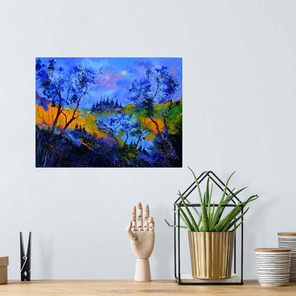 A bohemian room featuring Vibrant painting in blue tones of  trees, a colorful sky, and rolling hills in the distance.