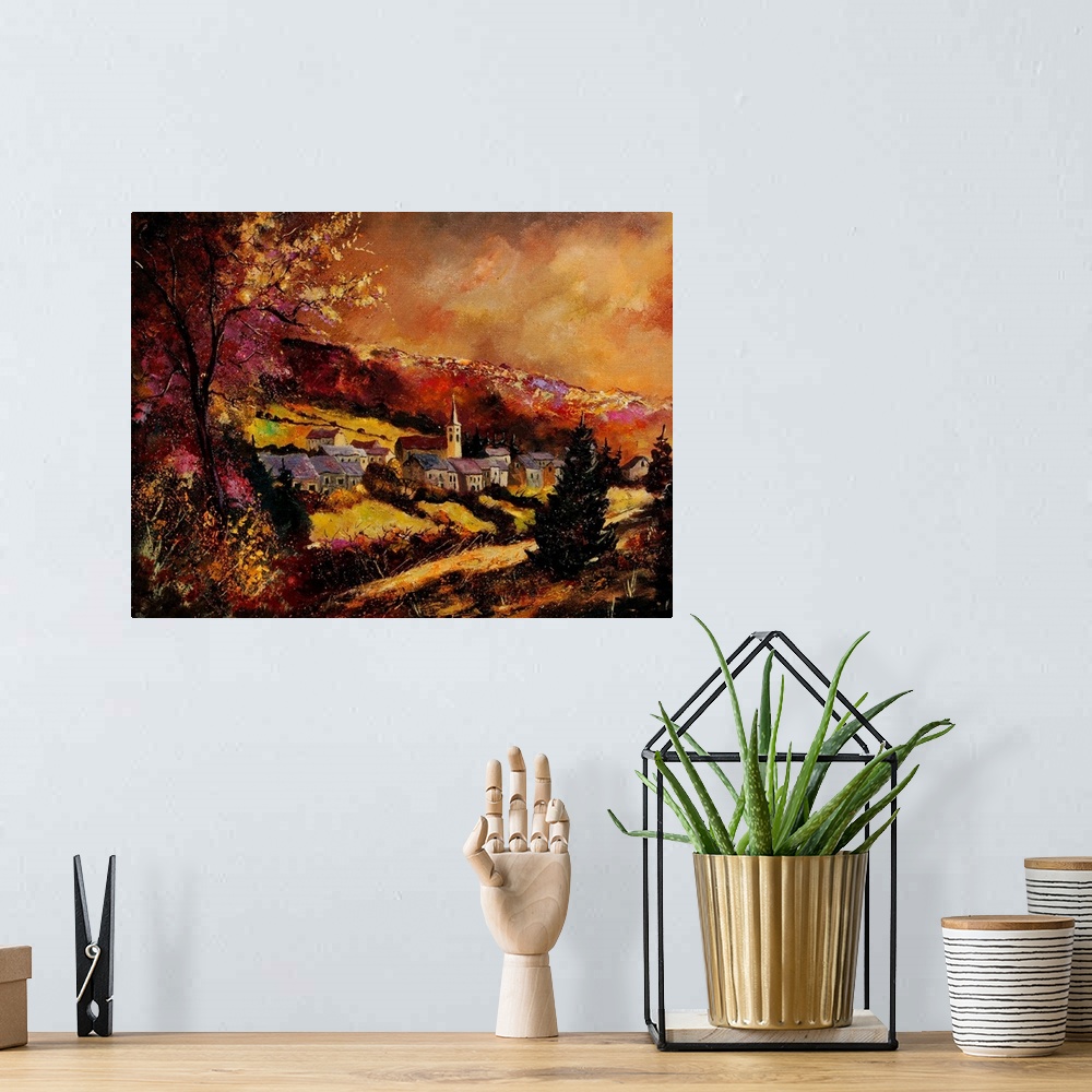 A bohemian room featuring A horizontal painting of the village of Vencimont in Belgium.