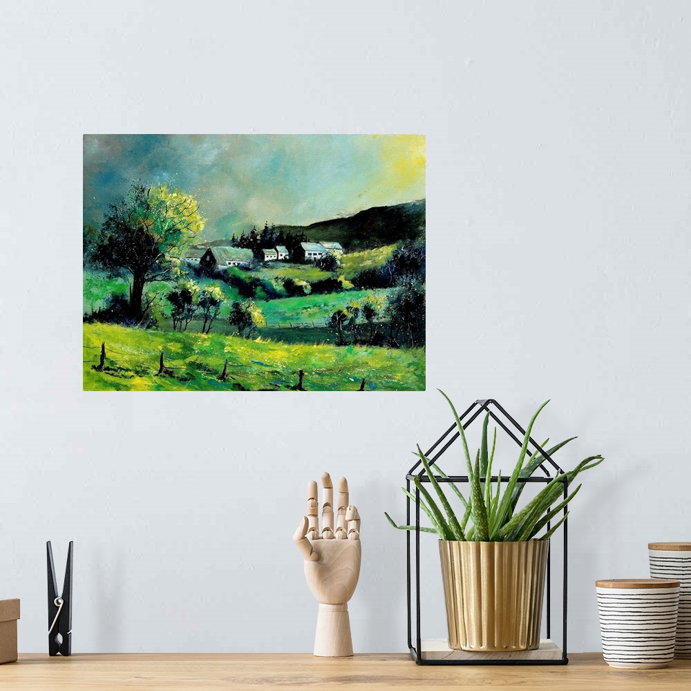 A bohemian room featuring Horizontal painting of a spring landscape with rolling fields in the foreground and a Belgium vil...