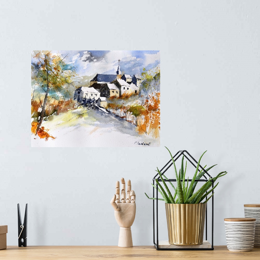 A bohemian room featuring A horizontal abstract landscape of a church with watercolors of brown, green and blue.