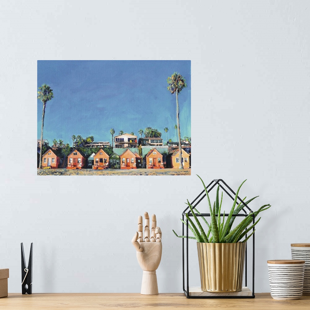 A bohemian room featuring Contemporary painting of a row of beach cottages with palm trees.