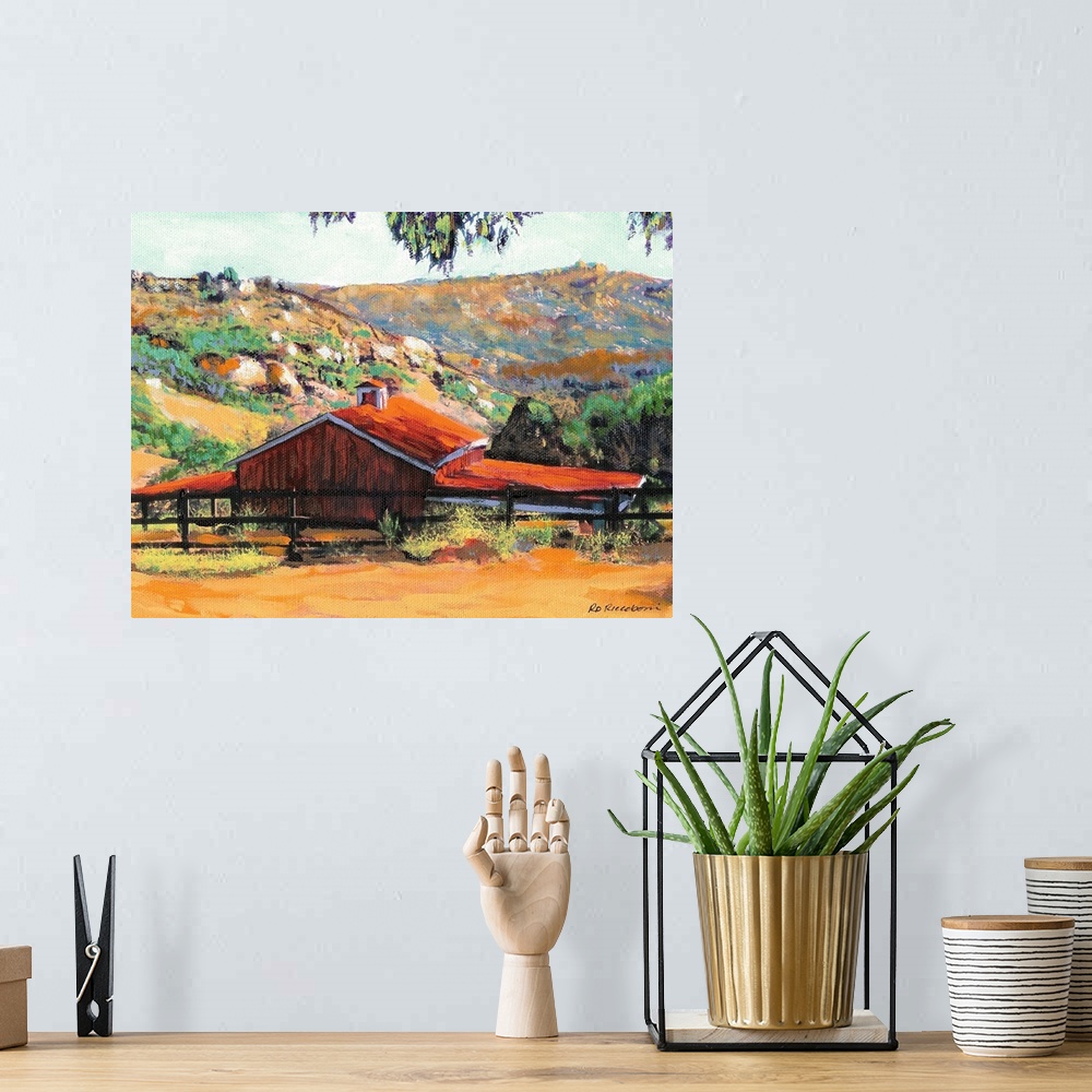 A bohemian room featuring Painting of a red barn at a ranch in San Diego with rolling hills in the background.