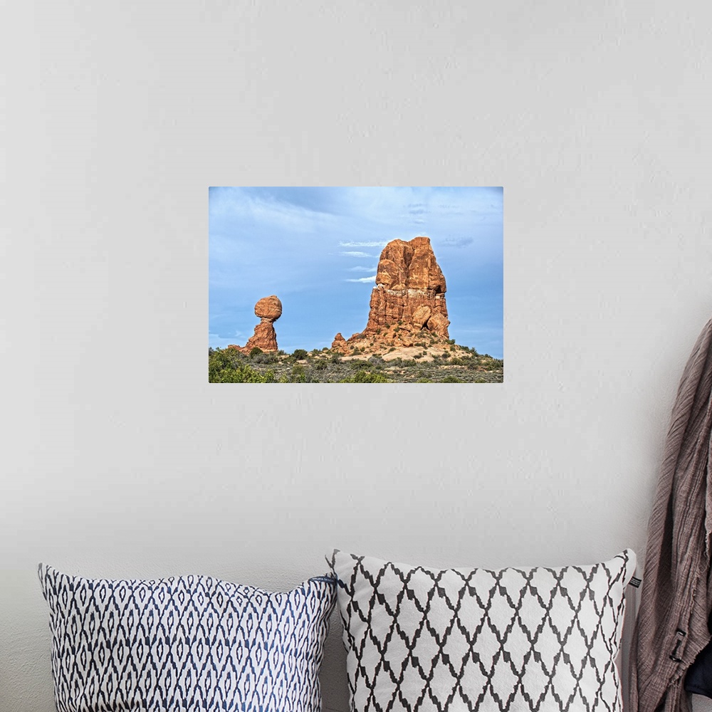 A bohemian room featuring Balanced Rock standing next to a sandstone rock formation under a cloudy sky, Arches National Par...