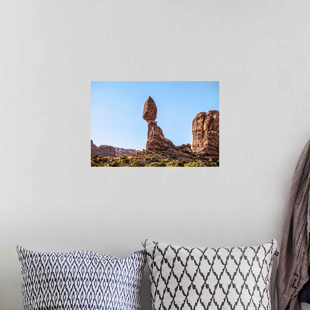 A bohemian room featuring Morning sunlight shining on the Balanced Rock sandstone formation, Arches National Park, Moab, Utah.