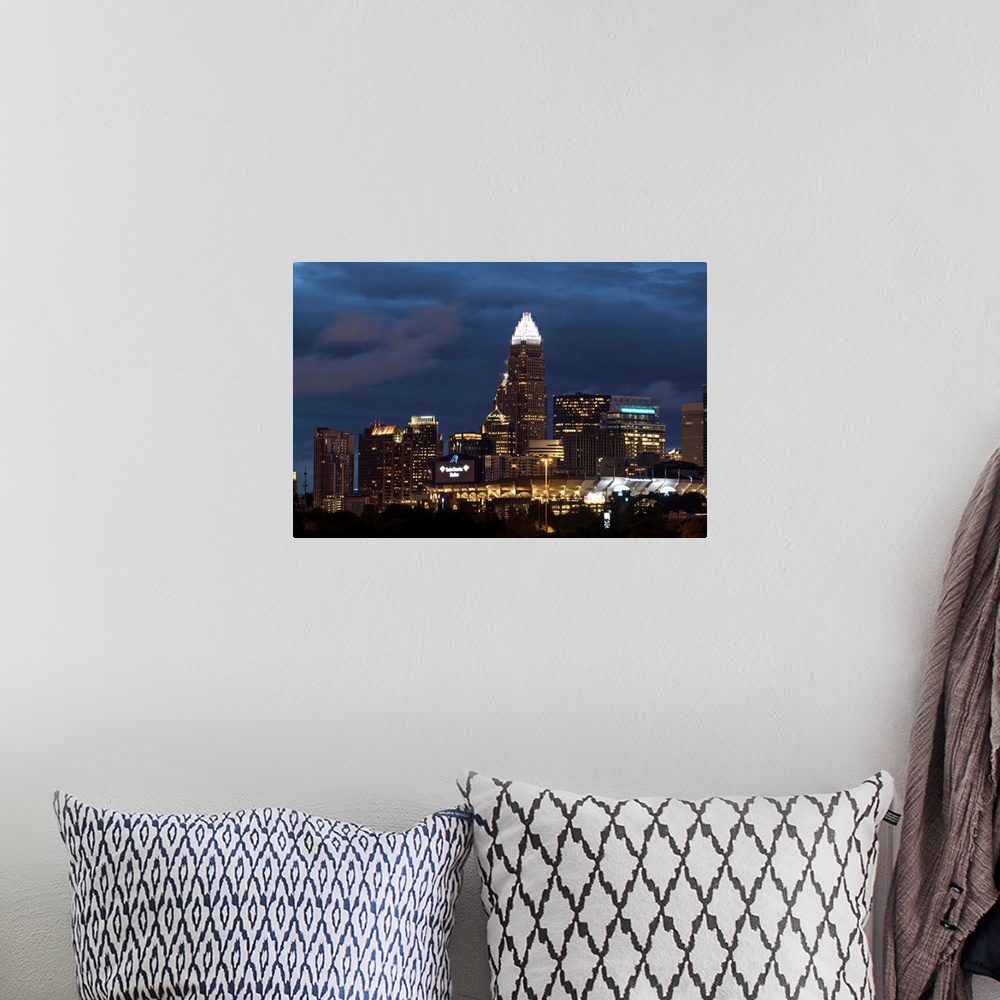 A bohemian room featuring Horizontal image of the city of Charlotte, North Carolina at night.