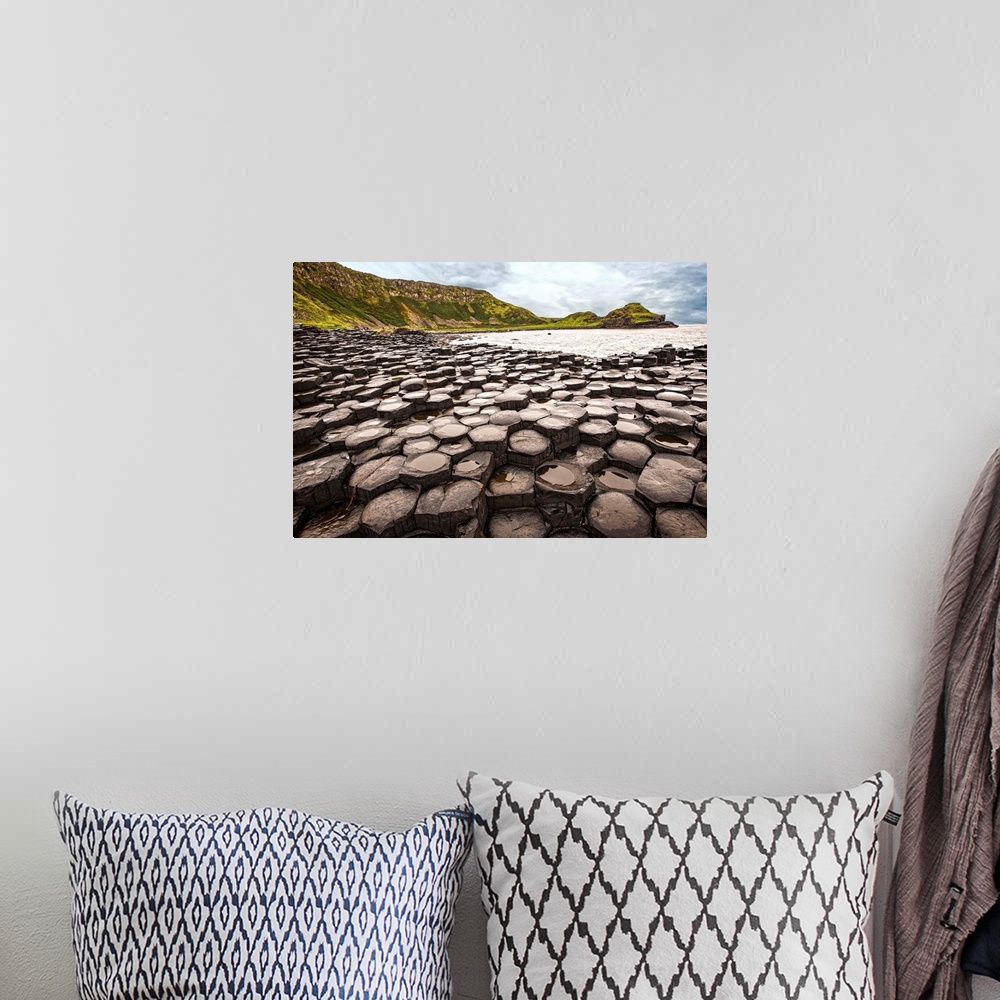 A bohemian room featuring Landscape photograph of the basalt columns on Giant's Causeway with rocky cliffs and the Atlantic...