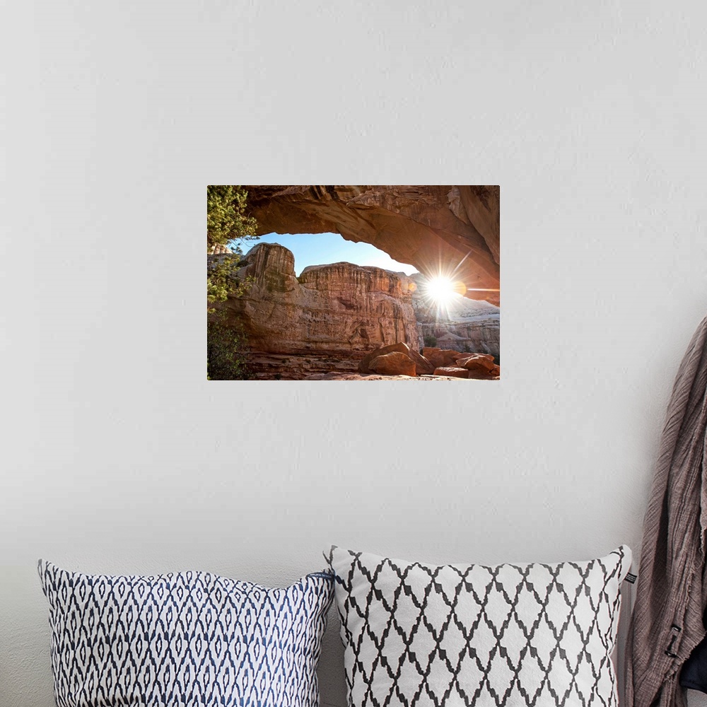 A bohemian room featuring The sun peeking through Hickman Bridge arch at Capitol Reef National Park in Utah.
