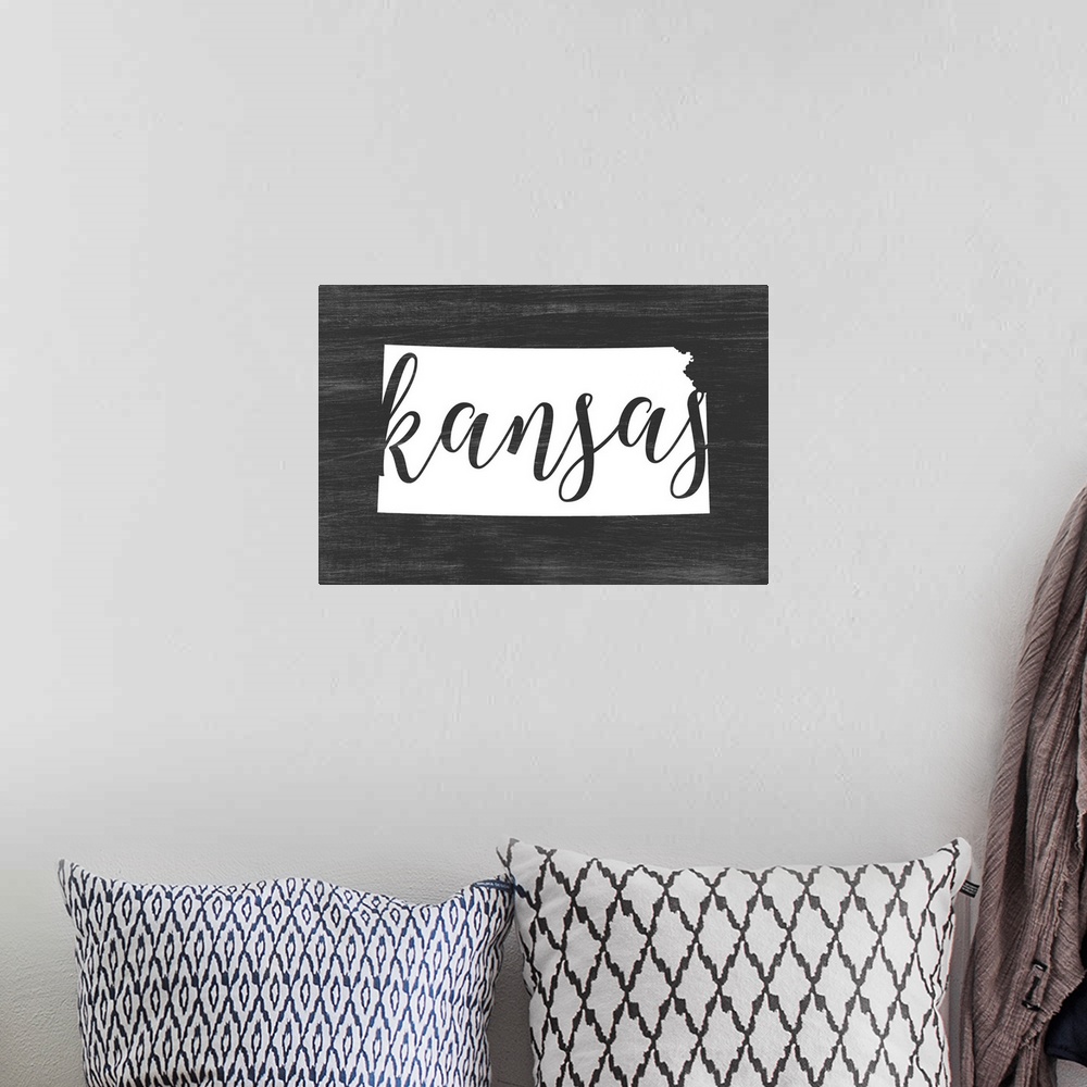 A bohemian room featuring Kansas state outline typography artwork.