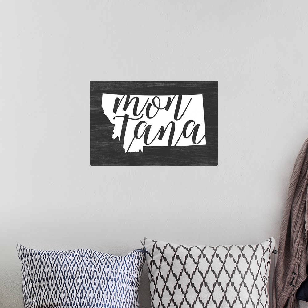 A bohemian room featuring Montana state outline typography artwork.