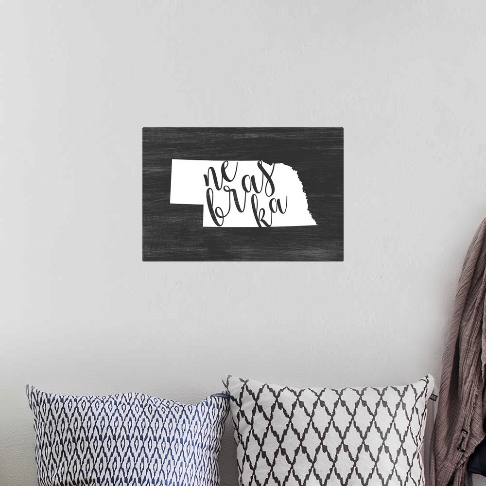 A bohemian room featuring Nebraska state outline typography artwork.
