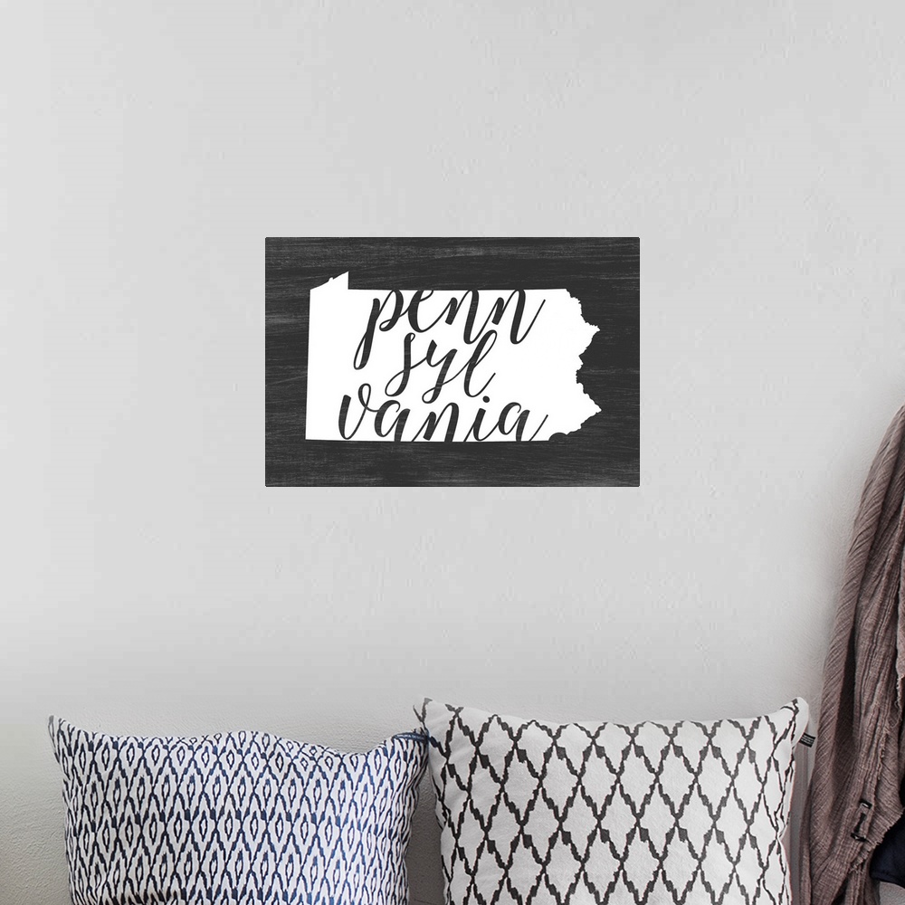 A bohemian room featuring Pennsylvania state outline typography artwork.