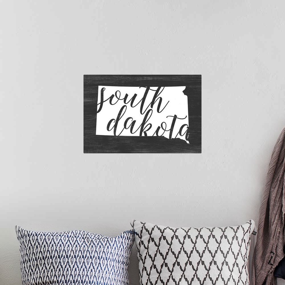 A bohemian room featuring South Dakota state outline typography artwork.