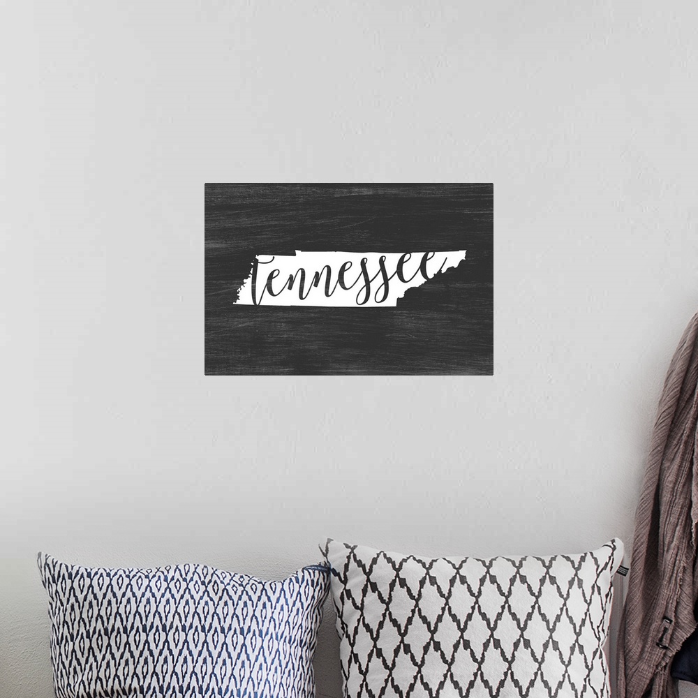 A bohemian room featuring Tennessee state outline typography artwork.
