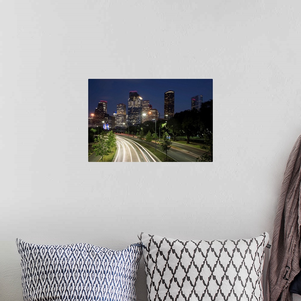A bohemian room featuring Long exposure photograph of the Houston TX skyline at night from the highway with red and white l...