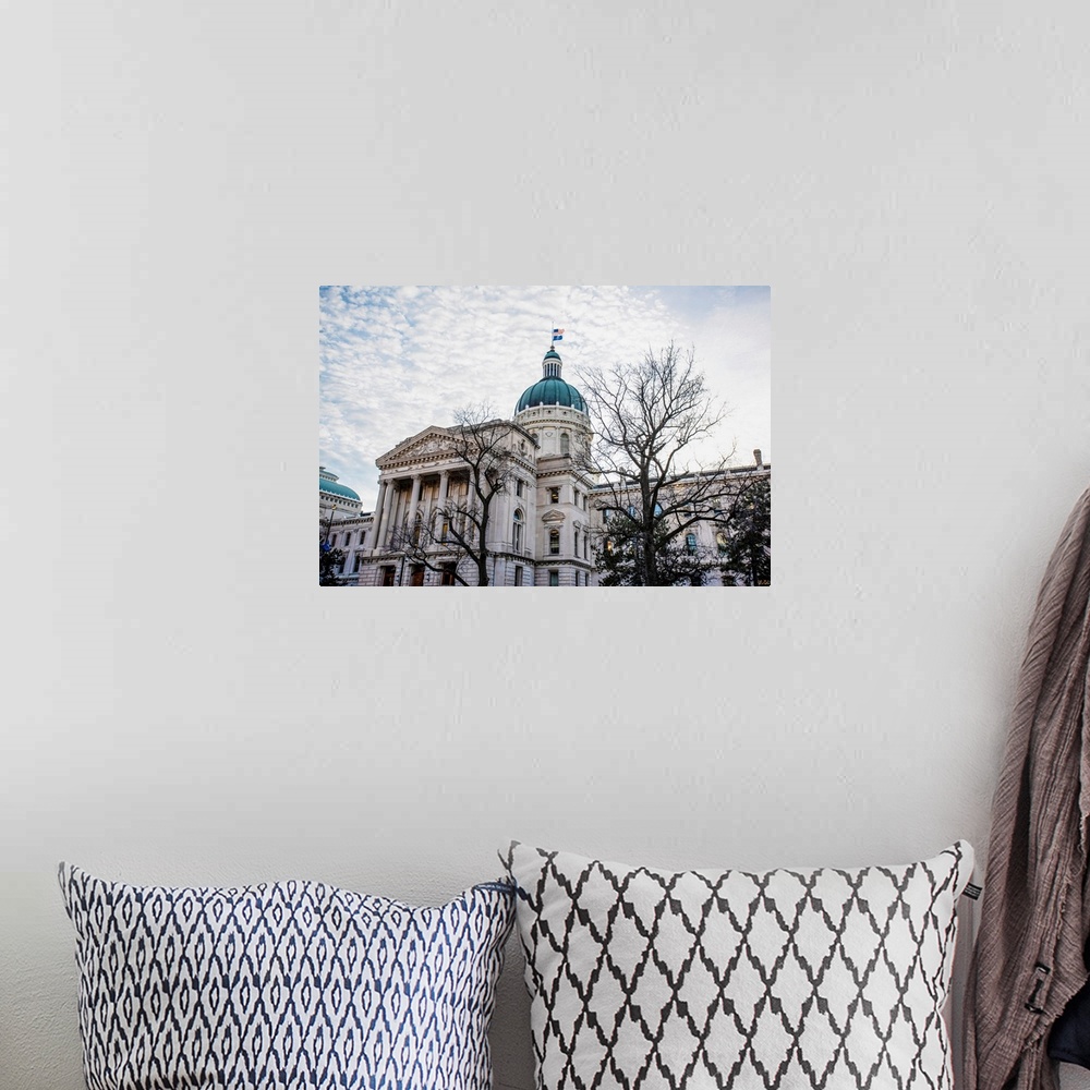 A bohemian room featuring Photo of the Indiana State House under puffy clouds.